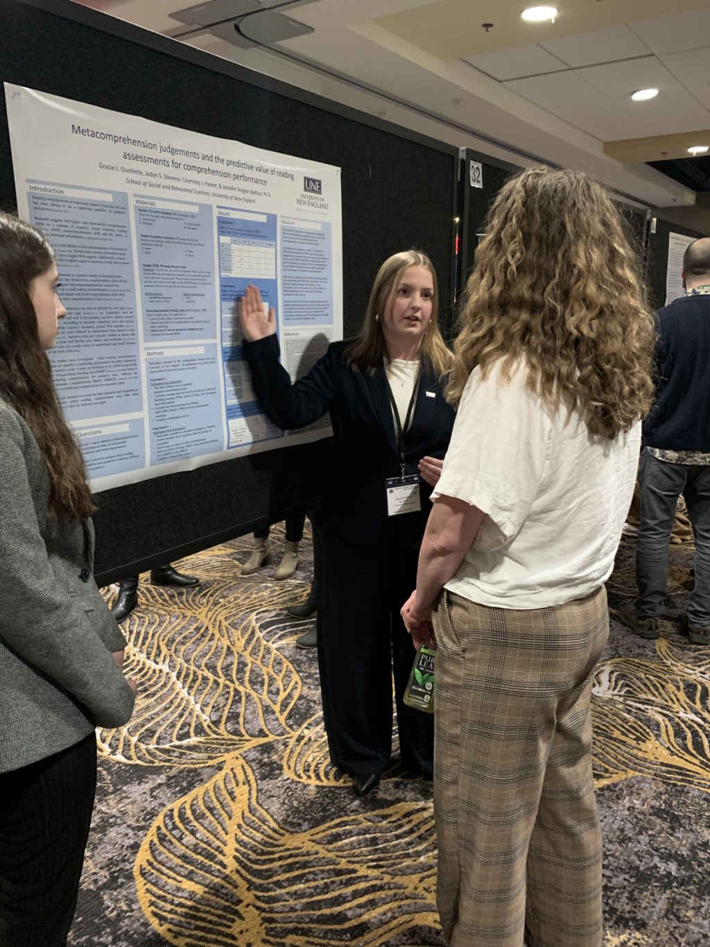 A female student presents her research poster