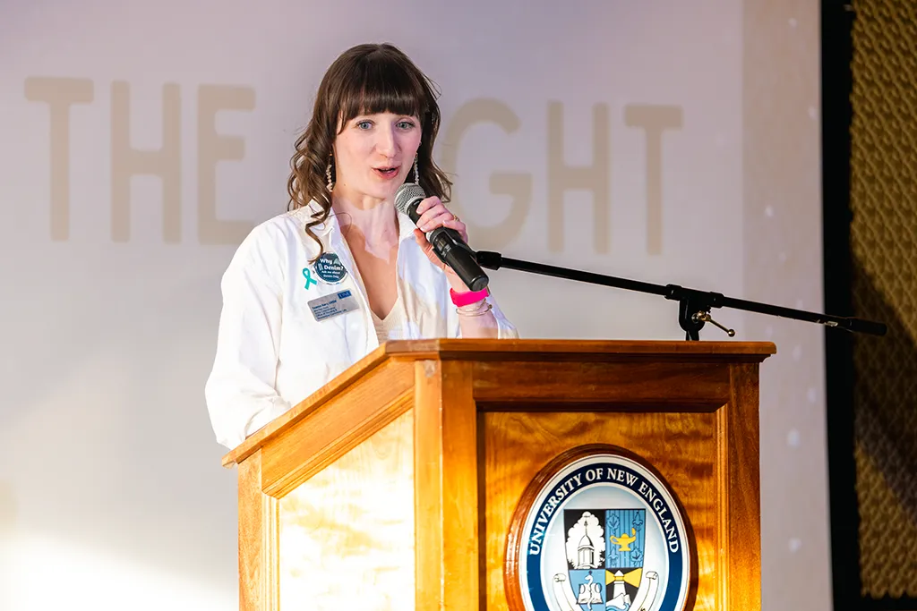 A woman speaks at a podium