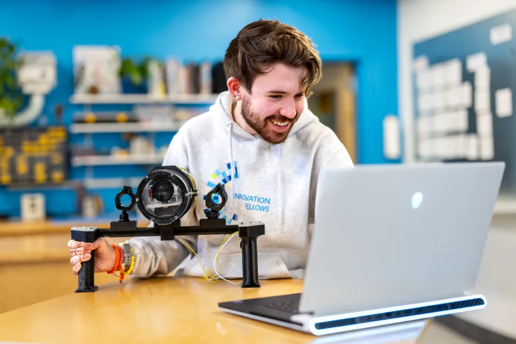 A student works on a laptop in the Makerspace