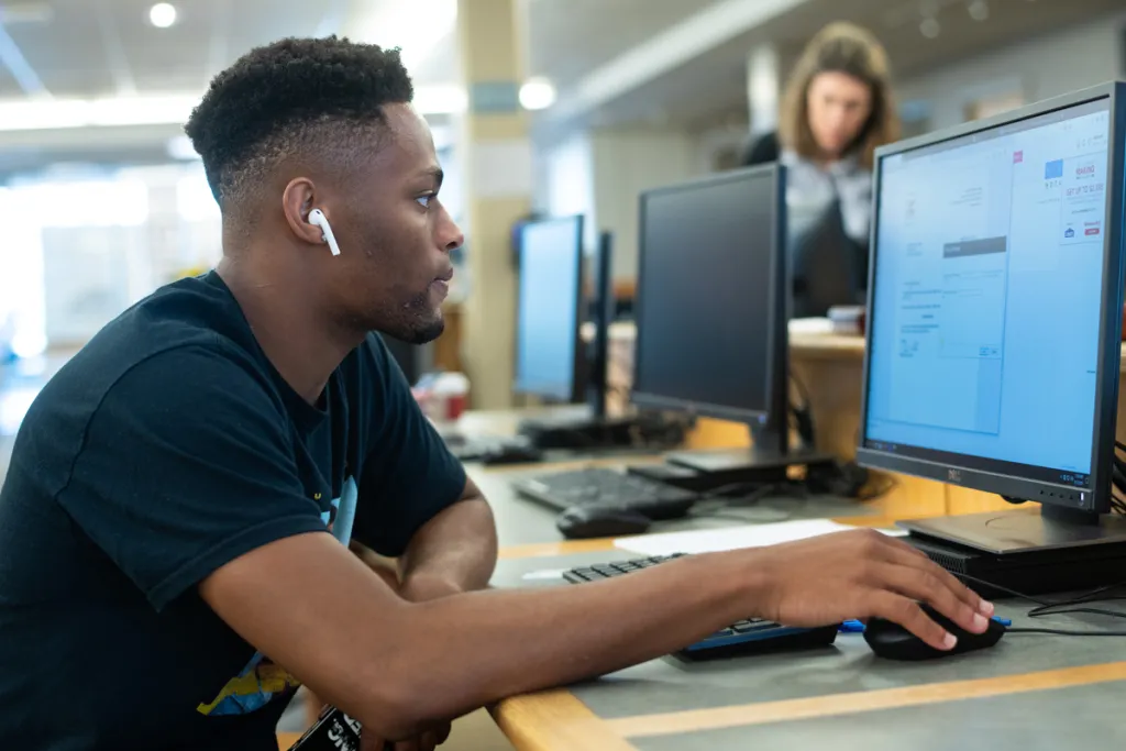 A student works on a computer in the Ketchum library