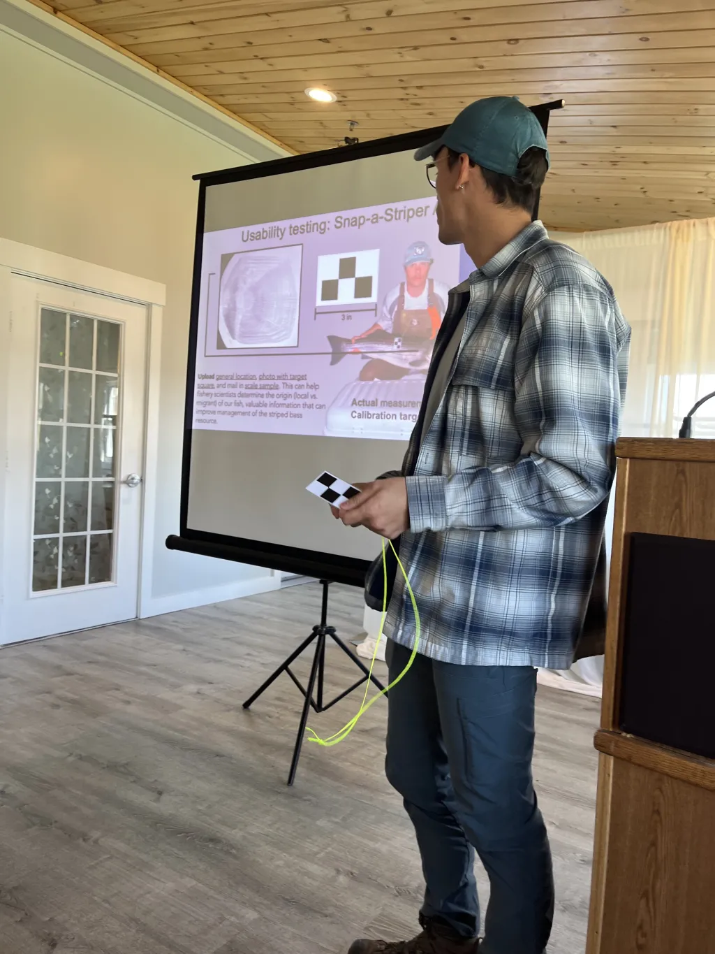 A UNE student presents a slideshow to a room of people
