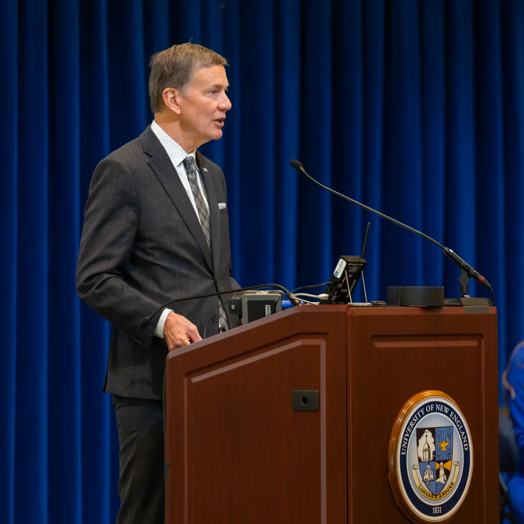 UNE President James Herbert speaks at the podium