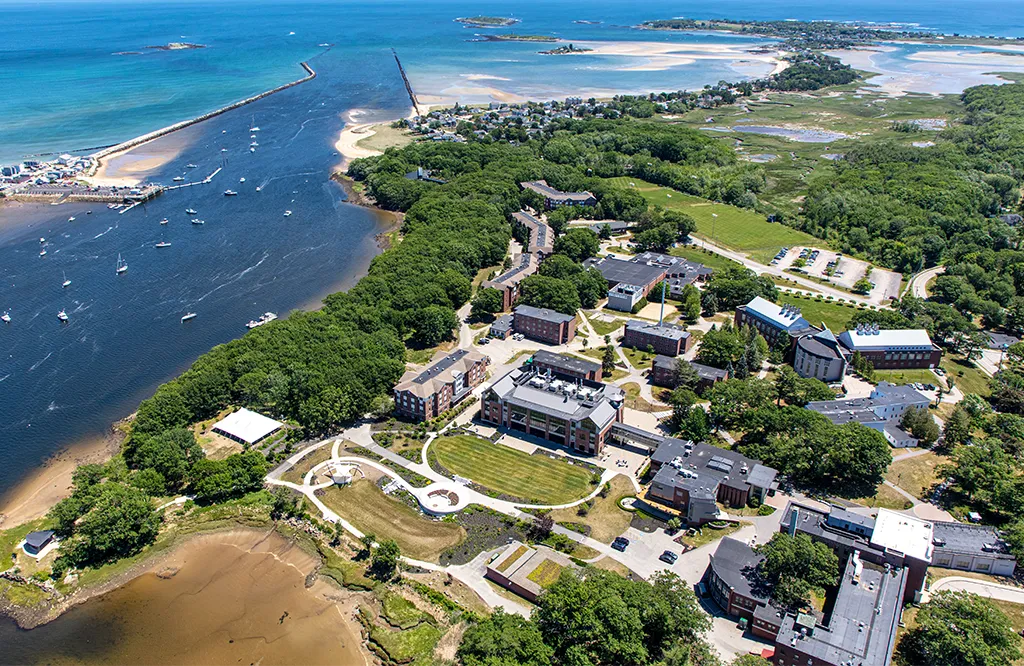 An aerial photo of the Biddeford Campus including the Saco River and Atlantic Ocean