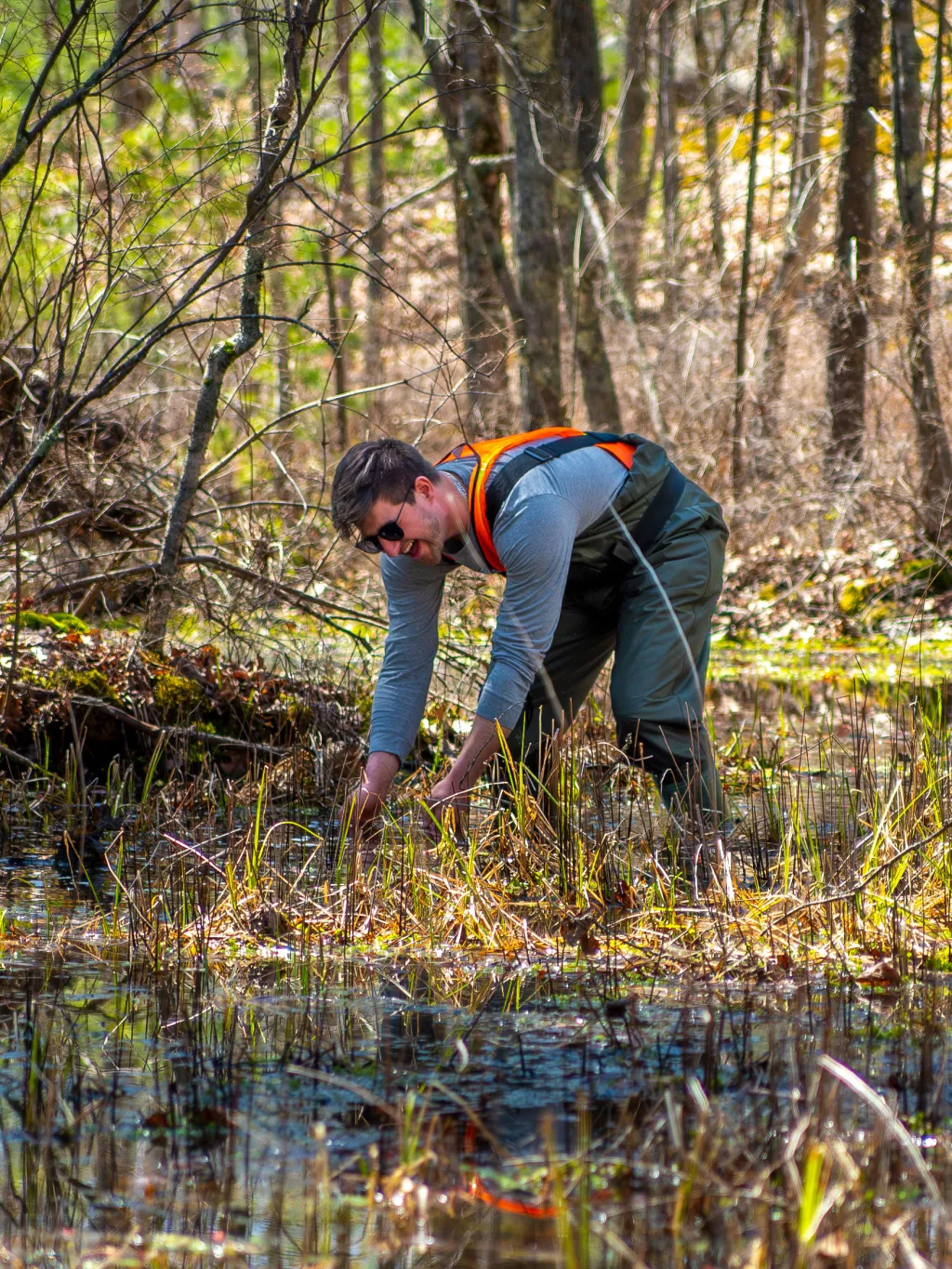 Student Brady Feola conducts field work in the vernal pools