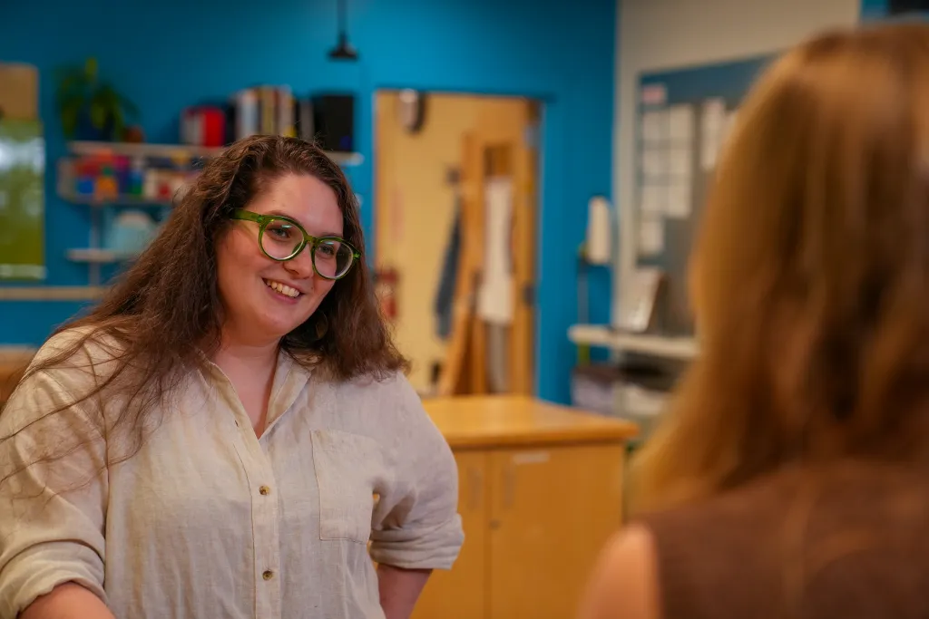Sophia Crockett-Current smiling at Jessica Howard in the Makerspace.