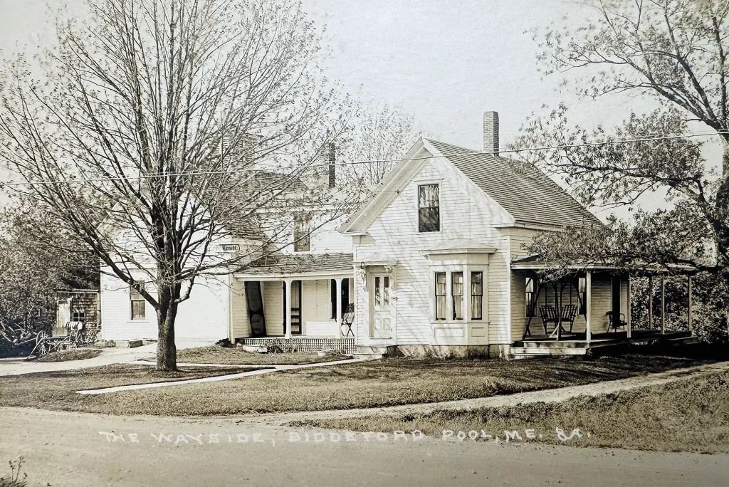 Historical photograph of The Wayside, a white Victorian-style house with wraparound porch that served as a shore dining hall and later as part of St. Francis College.