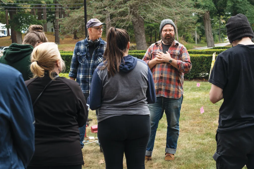 Arthur Anderson (left) and Eric Zuelow (right) speak to a crowd of students and alumni next to the dig location.