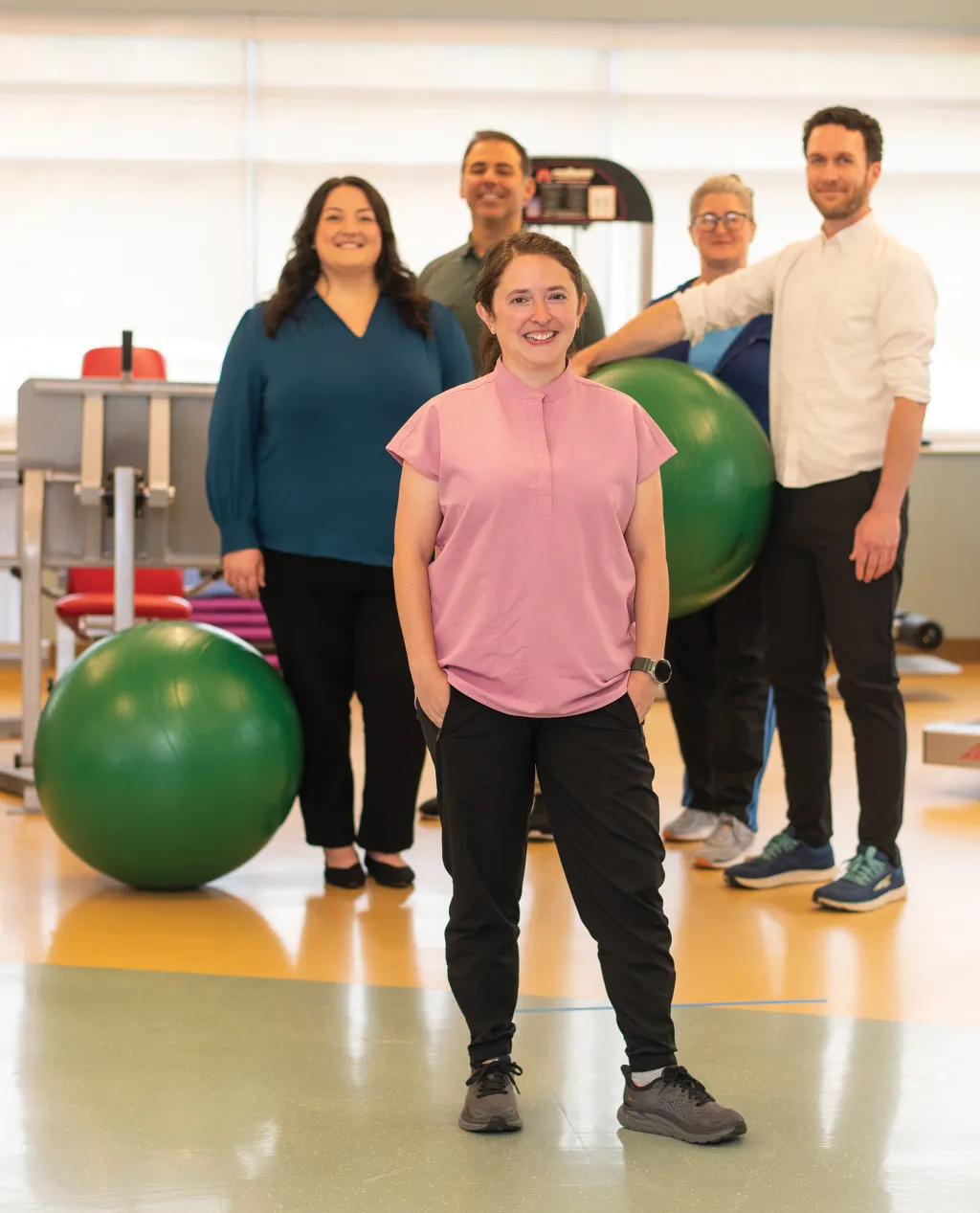 Occupational therapist Olivia Franceschelli stands with her interprofessional team in the functional restoration program gym at Dartmouth Hitchcock Medical Center in New Hampshire.
