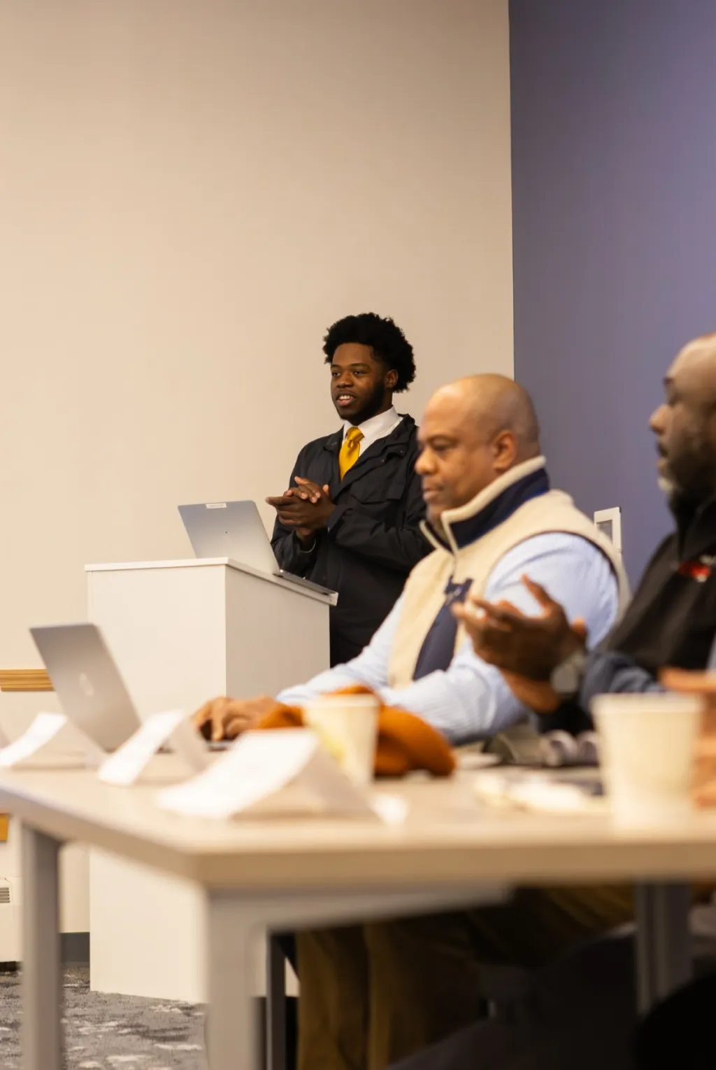 A student introduces a panel presentation