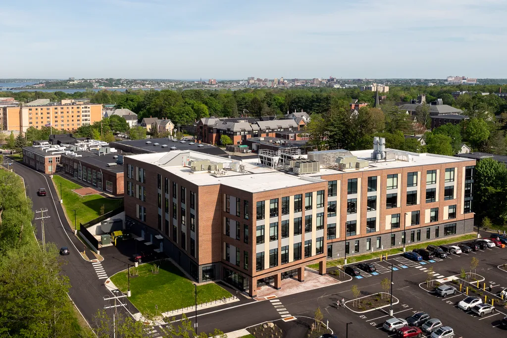 Aerial view of the Harold and Bibby Alfond Center for Health Sciences on UNE's Portland campus, with the city of Portland and Casco Bay visible in the background.