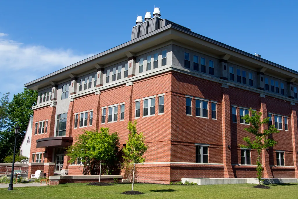 Exterior view of U N E's brick pharmacy building on Stevens Avenue on a sunny day.