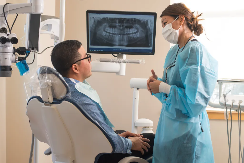 A Doctor of Dental Medicine student explains x-rays to a patient
