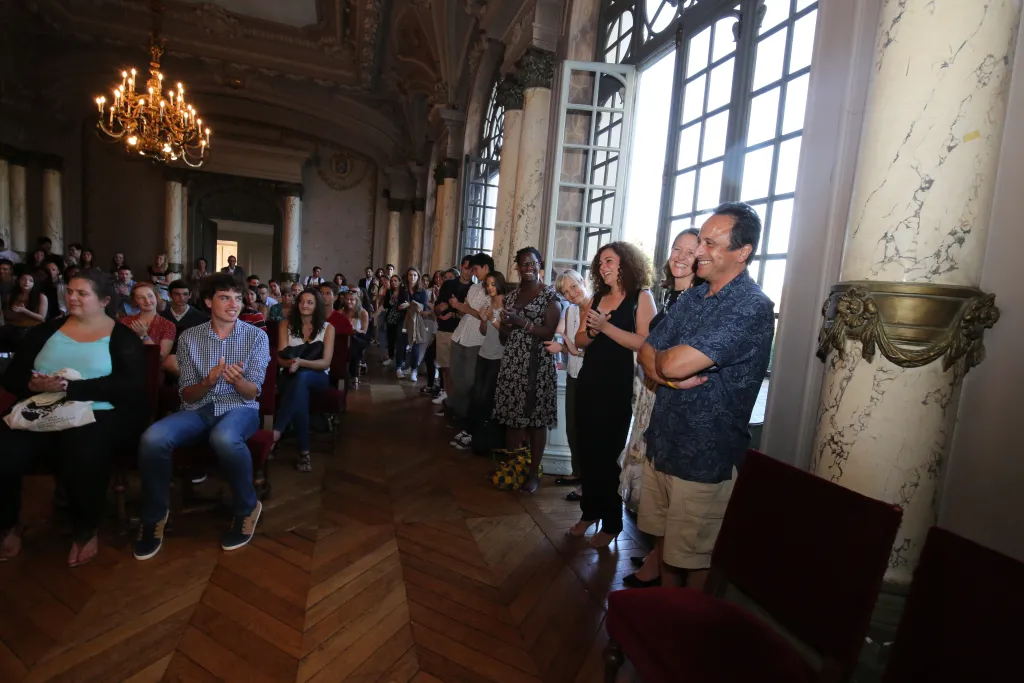 The crowd applauds UNE Vice President for Global Affairs and Communications Anouar Majid. 