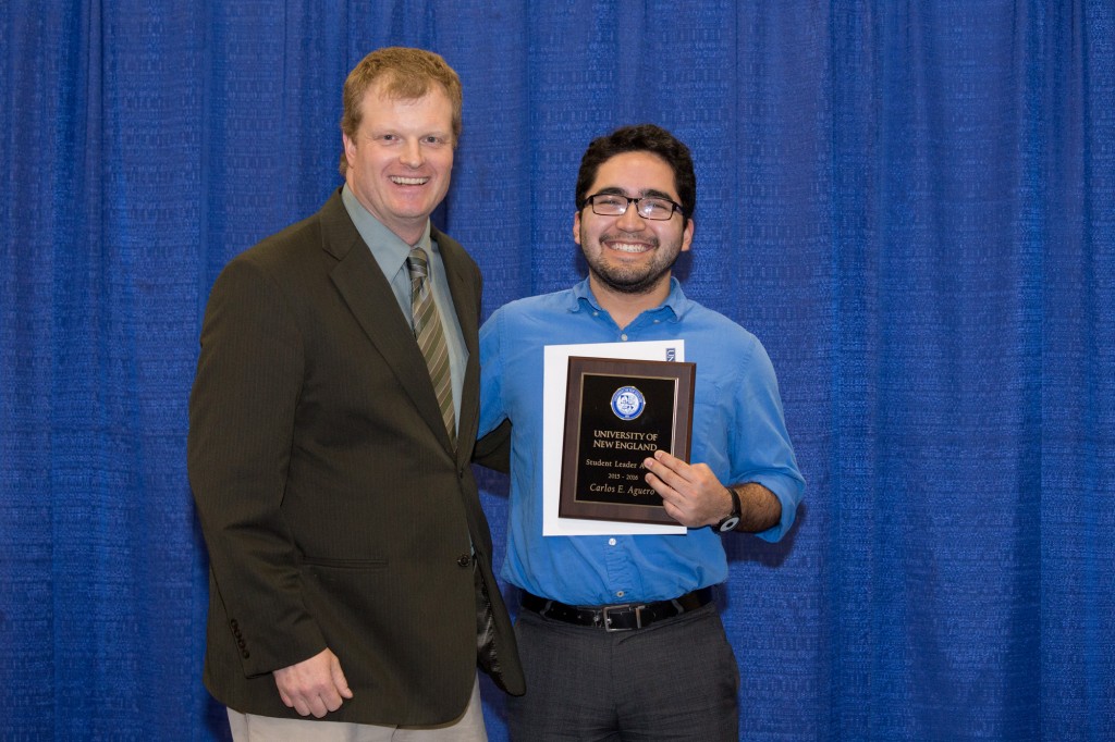 Recipient of the Student Leader Award Carlos Aguero accepts his award from Ryan Hedstrom, assistant lecturer in the Department