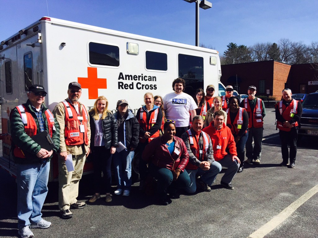 UNE volunteers pose with American Red Cross workers before heading out to install smoke detectors.