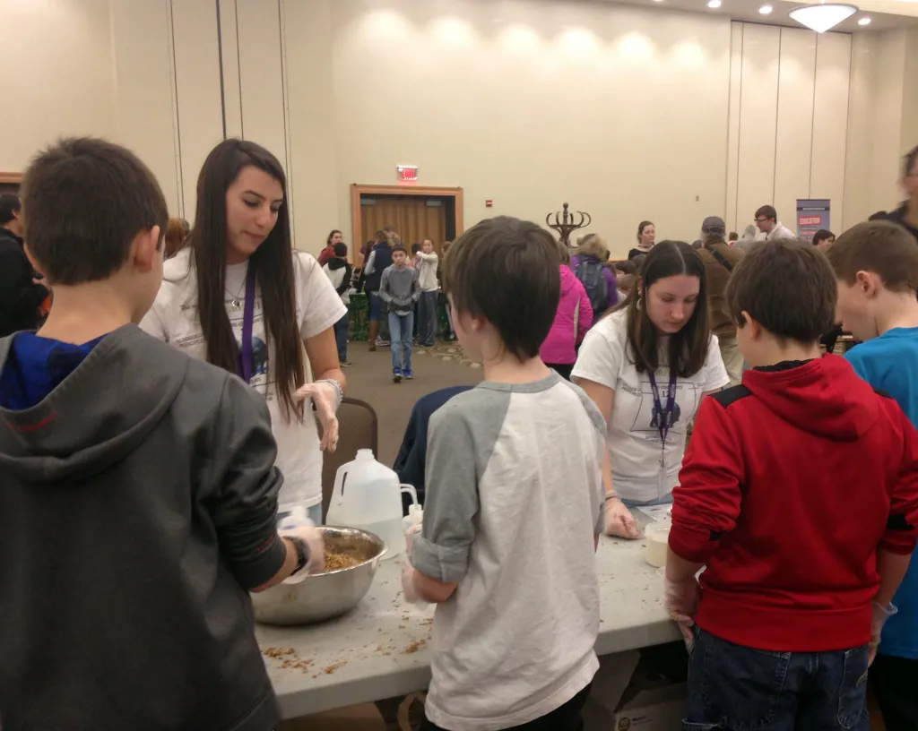 Jess Woolf and Megan Perry lead a group of students in a hands-on green chemistry activity of making “ecovative” shapes. Ecovati