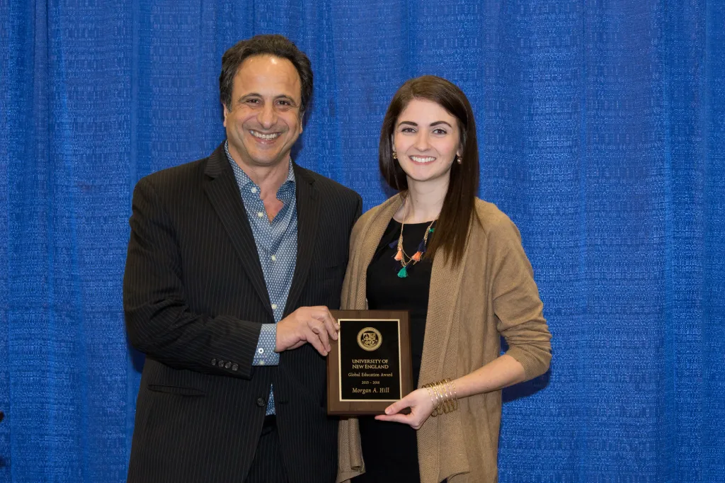 Morgan Hill receive the Global Education Award from Anouar Majid, vice president for Global Affairs and director of the Center f