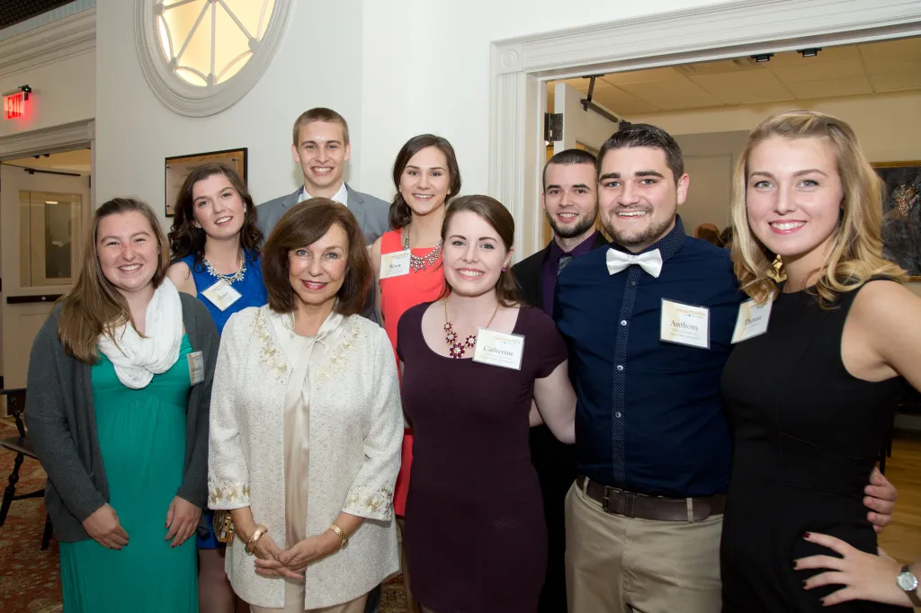A group of students gathers with President Ripich at the celebration.