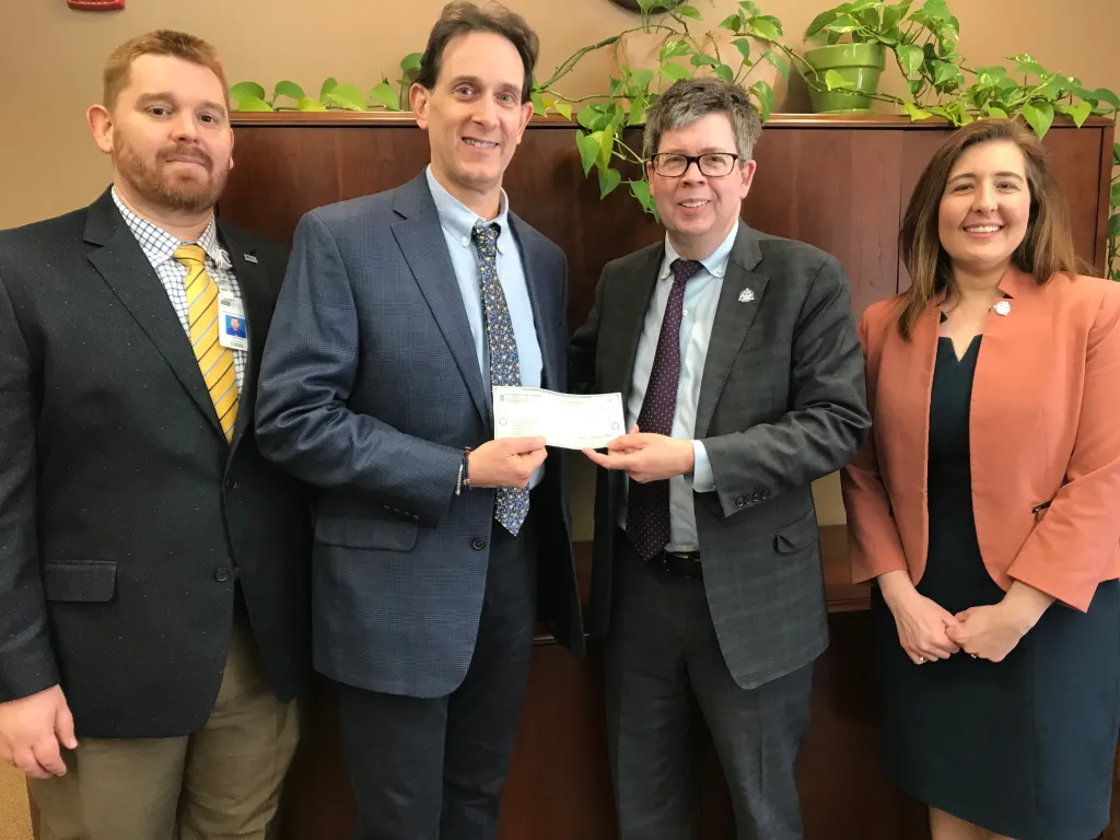 Barry Saltz presents a check on behalf of the International College of Dentists to Dean Ryder