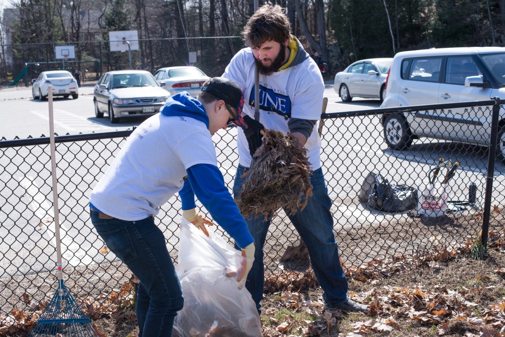 Matthew Organ (left) and Charlie Misenti perform spring clean-up at Clifford Park in Biddeford.