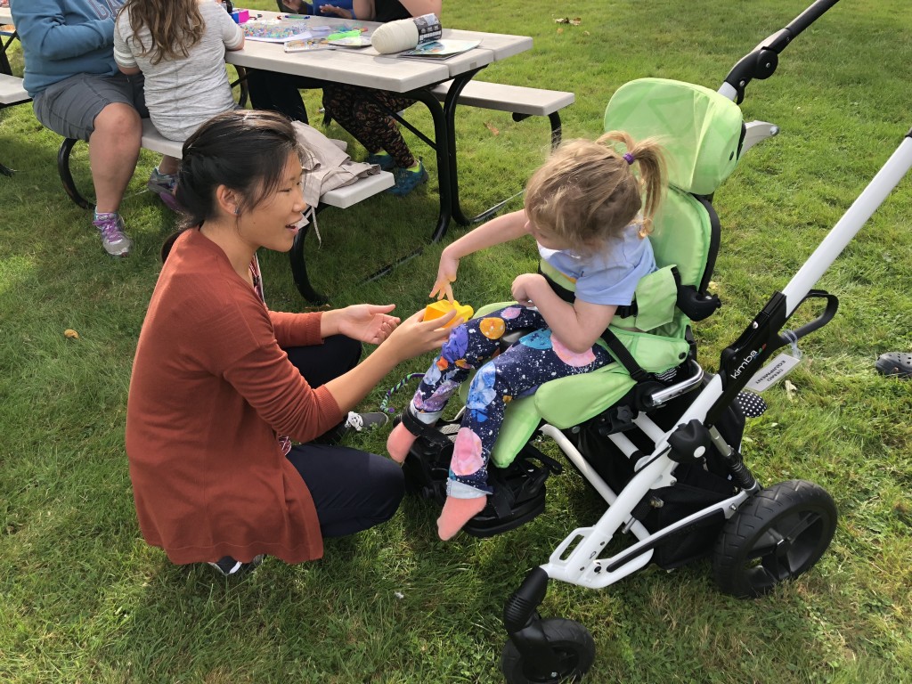 Denise Tso (DPT 2019) helps a child explore Playdoh