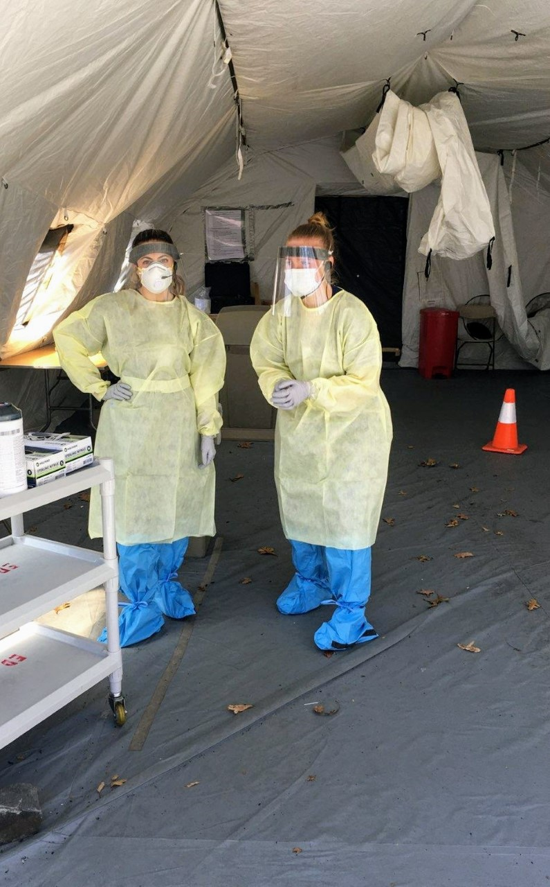 Jess D’Annibale (D.O., ’21), left, and Katelyn Chadwick (D.O., ’21) prepare to test patients for COVID-19 while wearing PPE
