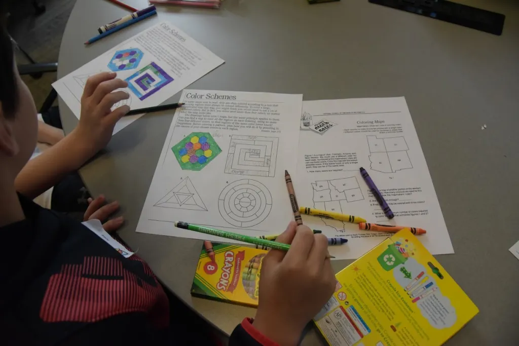 Students visited several tables that offered problem sets, games, or puzzles with mathematical themes
