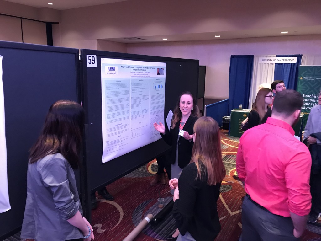 Courtney Parent explains her research on reading performance across text types to meeting attendees 