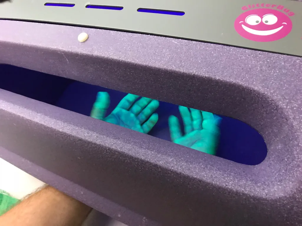 A visitor to the health fair checks for bacteria on his hands using the “Bug Light”