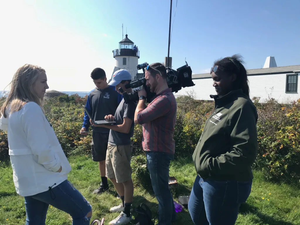 Students check wind data using a laptop computer