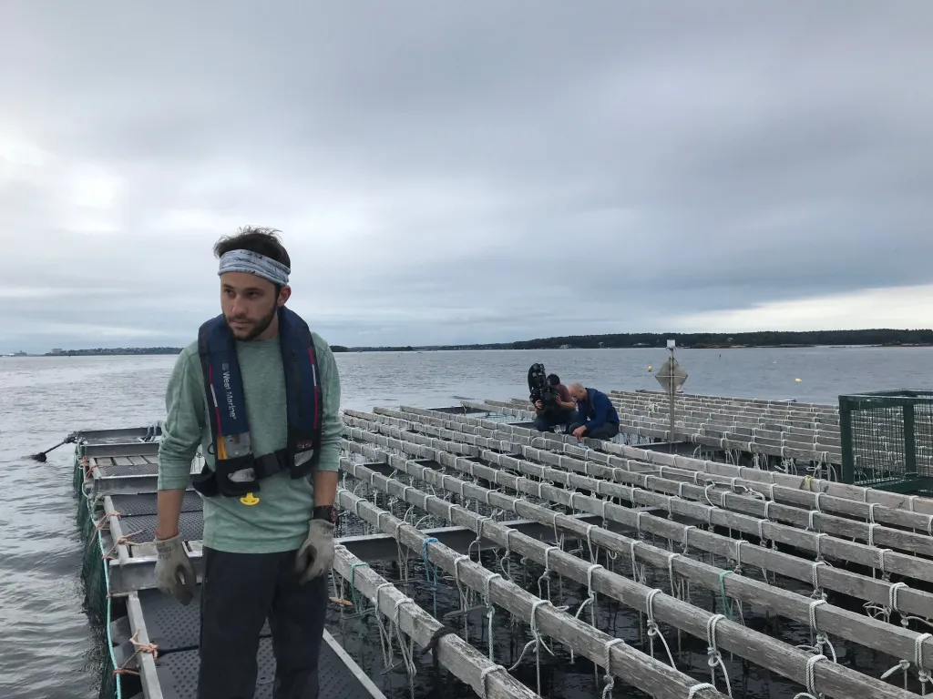 Connor Jones, pictured at Bangs Island Mussels in Casco Bay, presented on threats to blue mussels