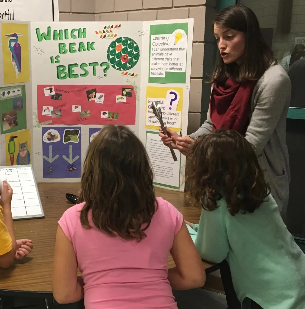 Phoebe Hopkins instructs students at her "Which Beak is Best" learning station.