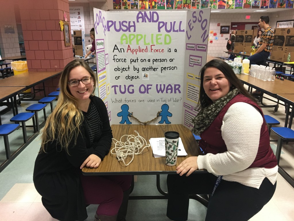 Amelia Coffey and Lilli Sundgren pose with their display for Family Science Night.