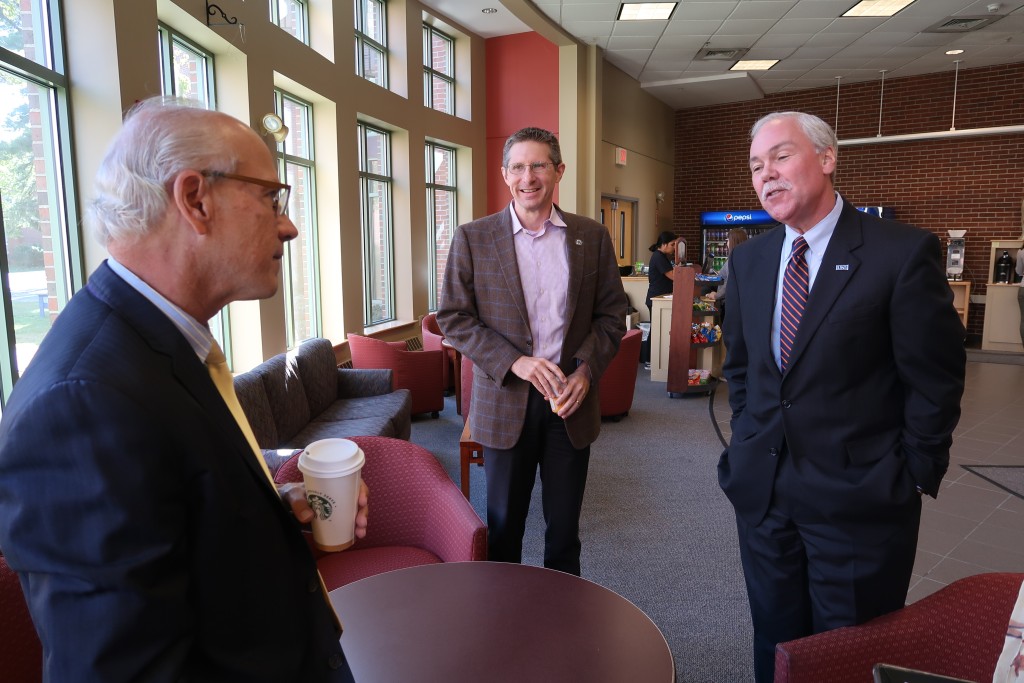 Gordon Smith chats with UNE's Ken McCall, a member of the governor's opioid response committee, and Dean Robert McCarthy