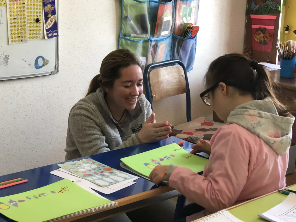 UNE physical therapy student Shelby Clare works with a student at the Wissal School.