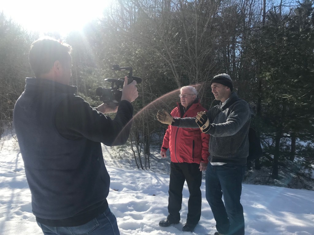 Noah Perlut on the Eastern Trail in Scarborough explaining his project to the WMTW crew