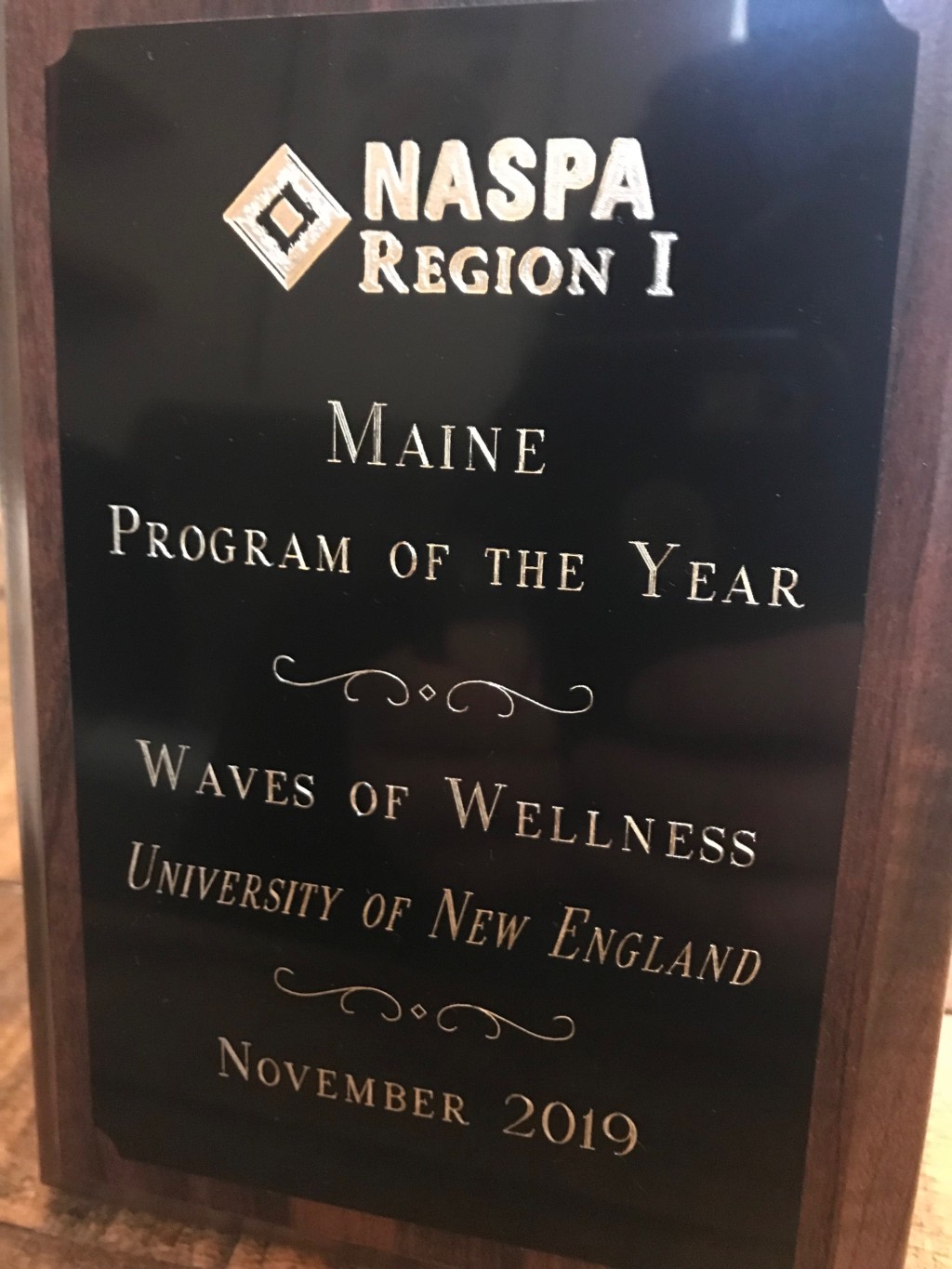 Plaque recognizing UNE's award-winning Waves of Wellness program