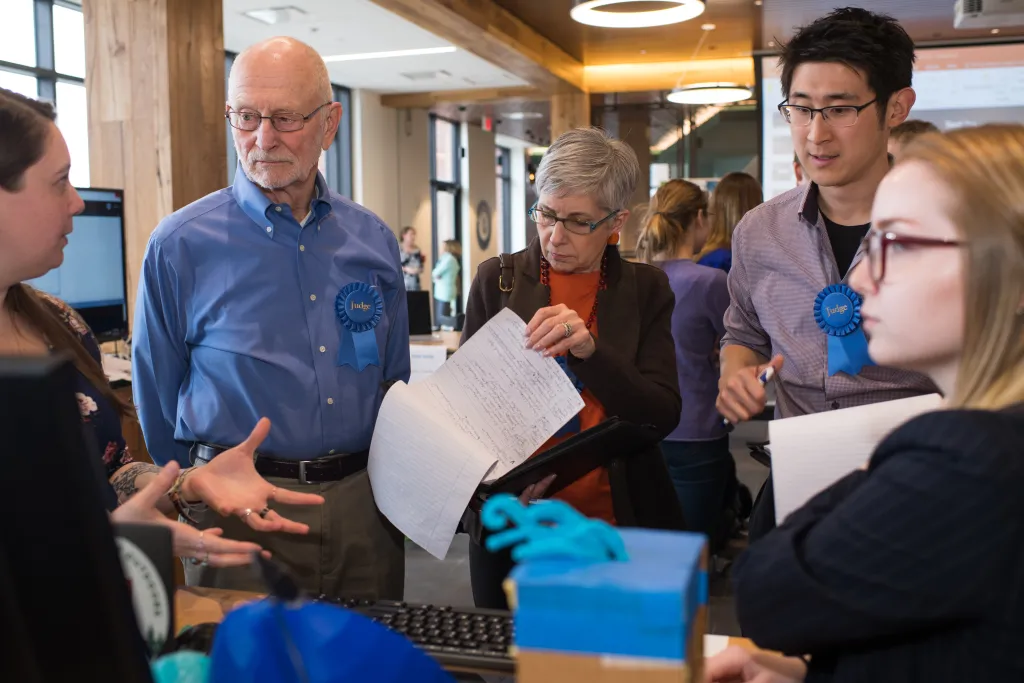 Students explain their projects to some of the competition's judges