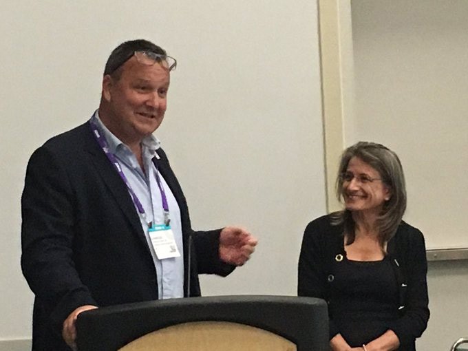 Jane Carreiro, D.O., is recognized by Osteopathic International Alliance board member Charles Hunt, D.O., for her leadership and
