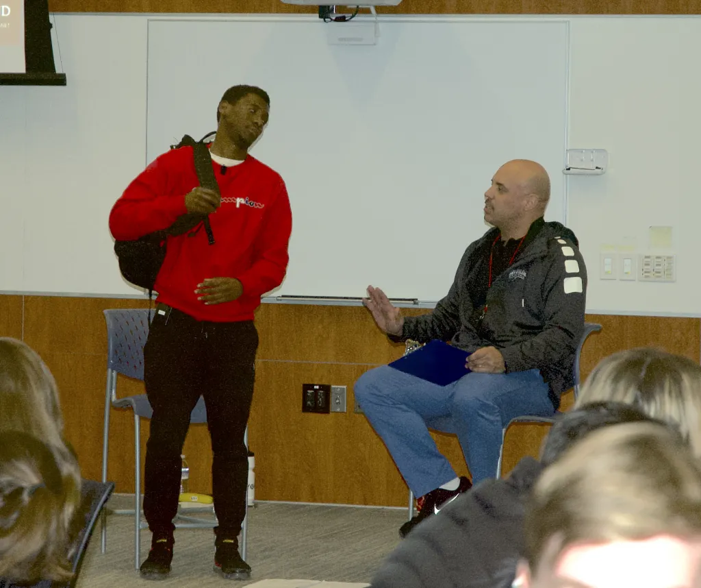 Jean Claude Butera acts out a scene with UNE head basketball coach Ed Silva