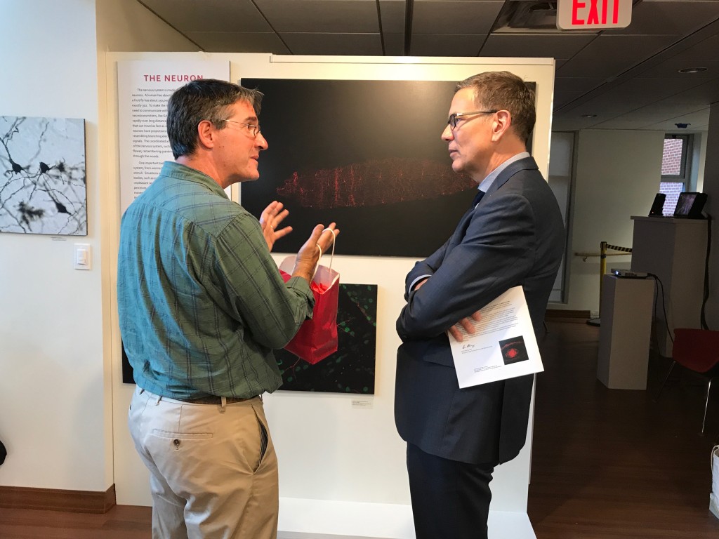 President James Herbert talks with Ian Meng at the exhibit opening