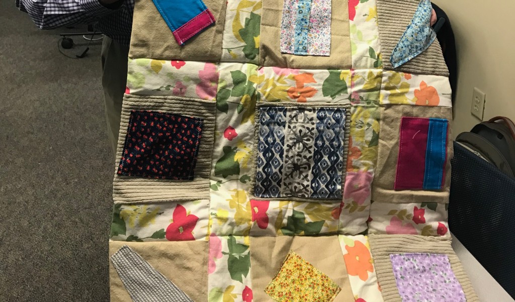 The quilt has nine pockets that can be filled with small items