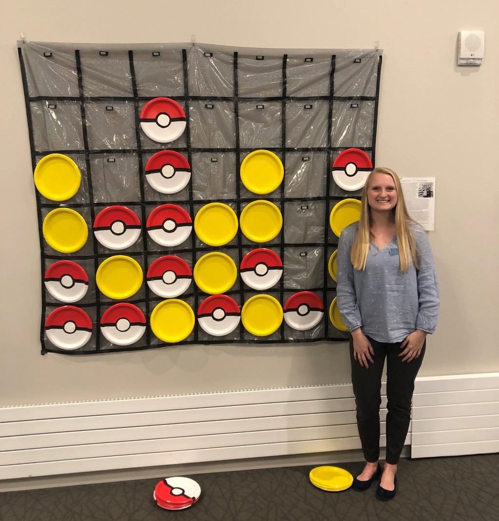 Kylie Copland shows off the custom “Connect Four” game she made for a client.
