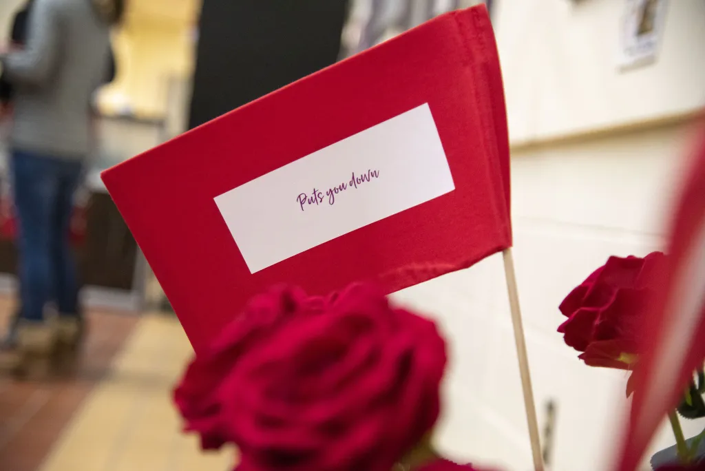 McLean's exhibit also educates viewers on the signs of domestic abuse, depicted here as "red flags" among a bouquet of roses.