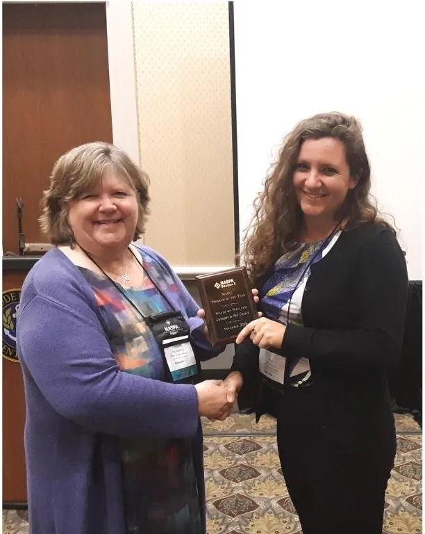 Eryn Neptune receives the Outstanding Program of the Year Award for Maine from NASPA