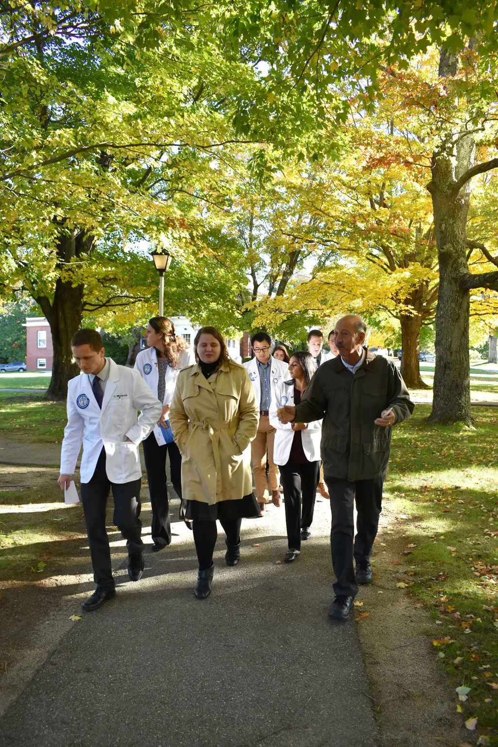 Jon Mistos, senior director of facilities and support services at Sweetser, leads COM students on a tour of the grounds.