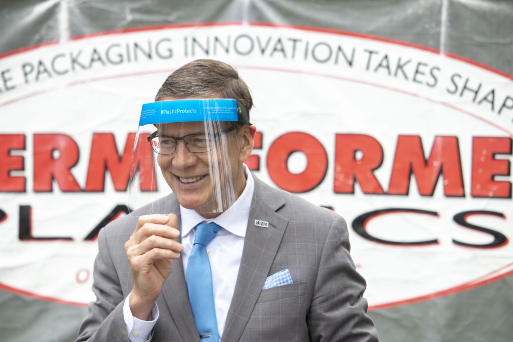 President Herbert wears a face shield manufactured by Biddeford-based Thermoformed Plastics of New England.