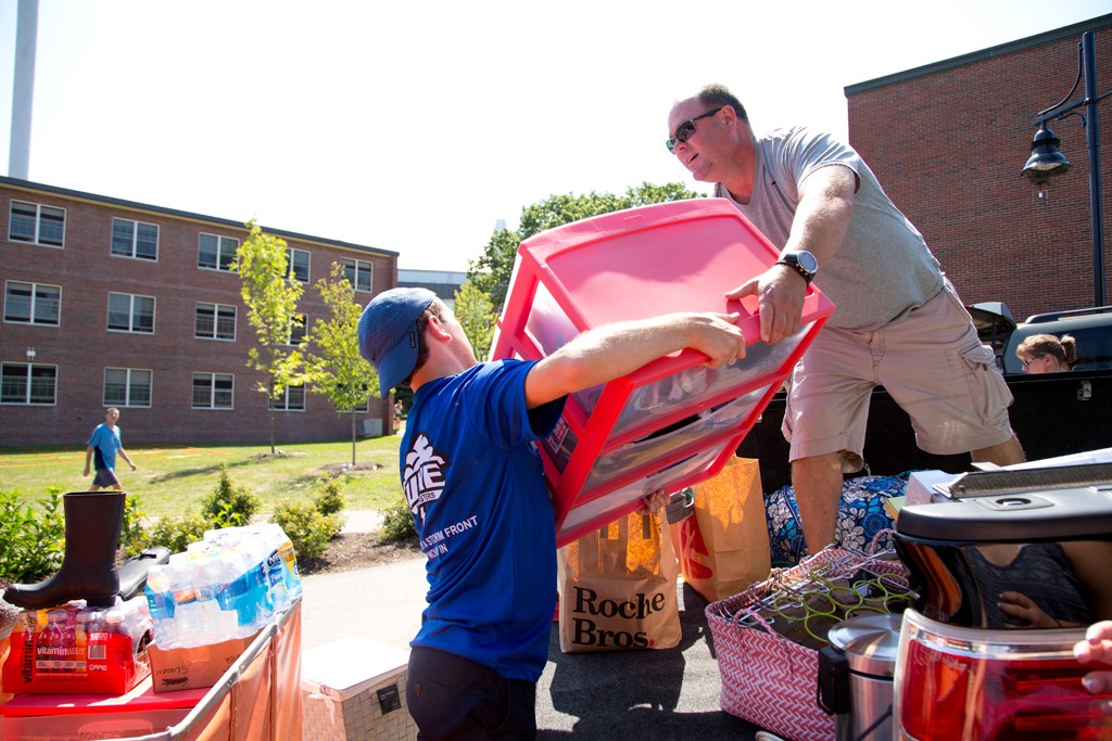 A Storm Front volunteer lends a hand on move-in day.