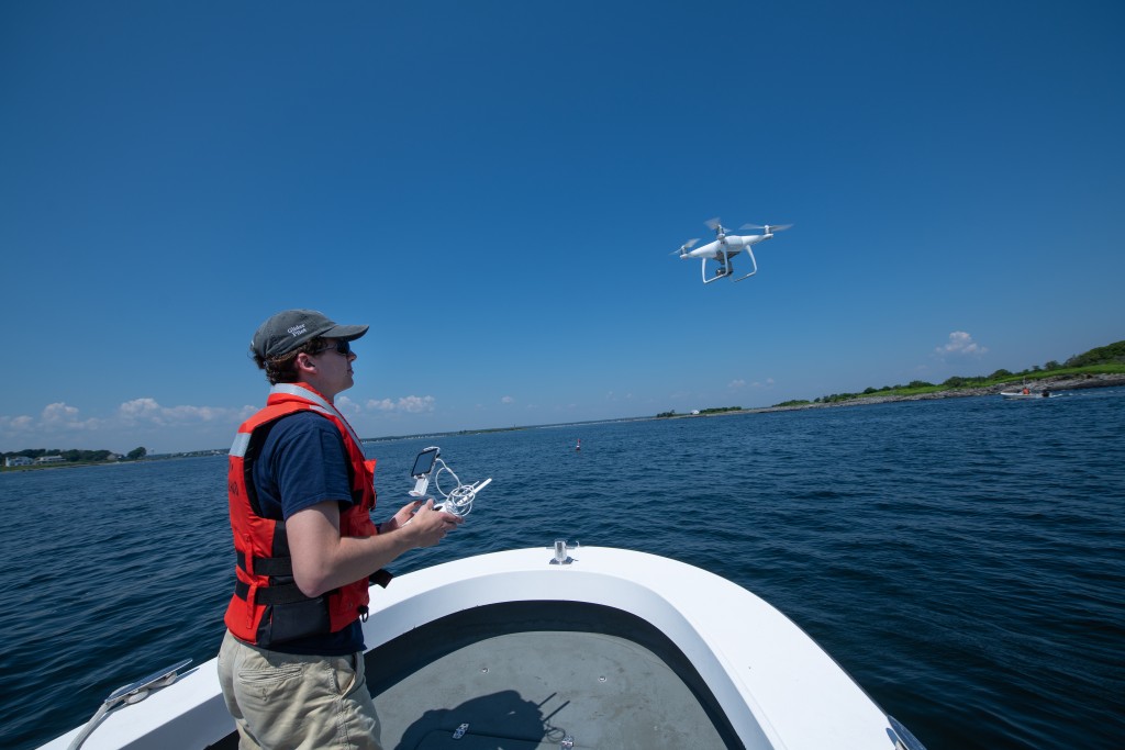 Andy Robinson launches a drone from UNE's research vessel R/V Llyr to record imagery in Wood Island Harbor