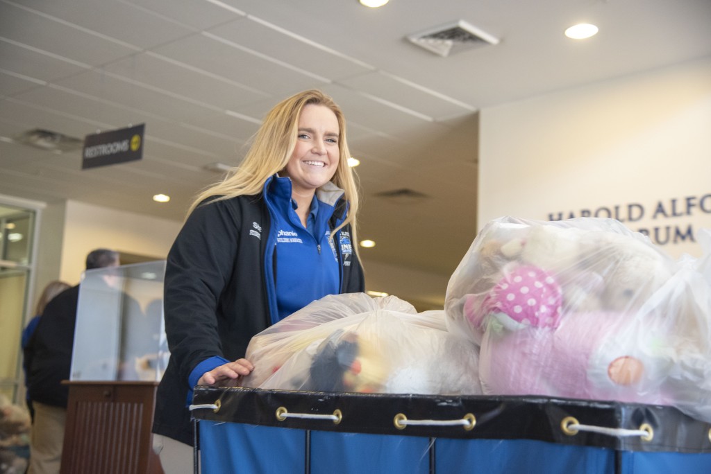 UNE student Stephanie Devine carts dozens of teddy bears to be donated to the United Way of York County.